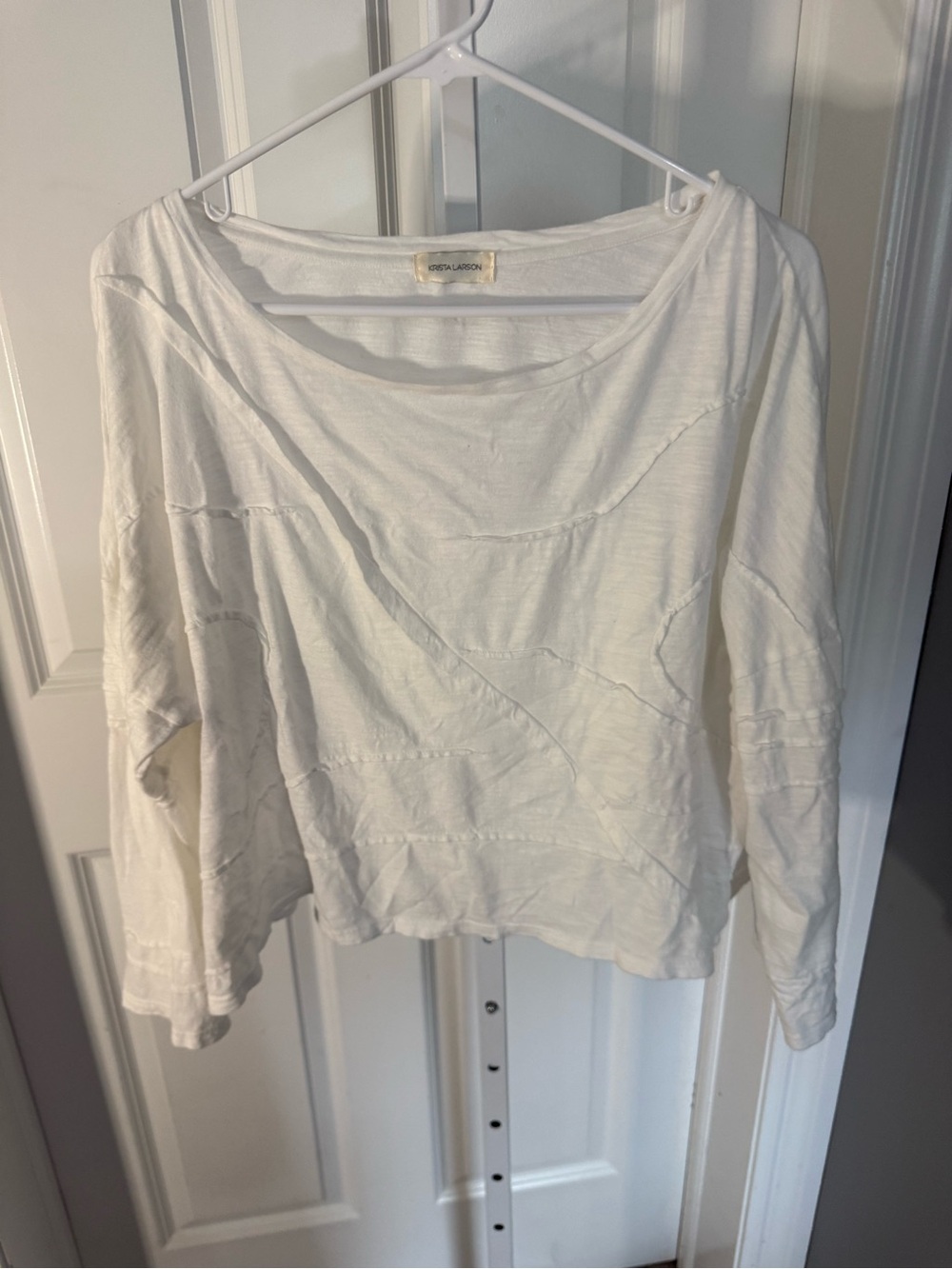 a Krista Larson raw-edge patchwork cotton pullover top
